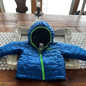 The North Face Blue Hooded Jacket with Green Accents Size 3-6 Months.